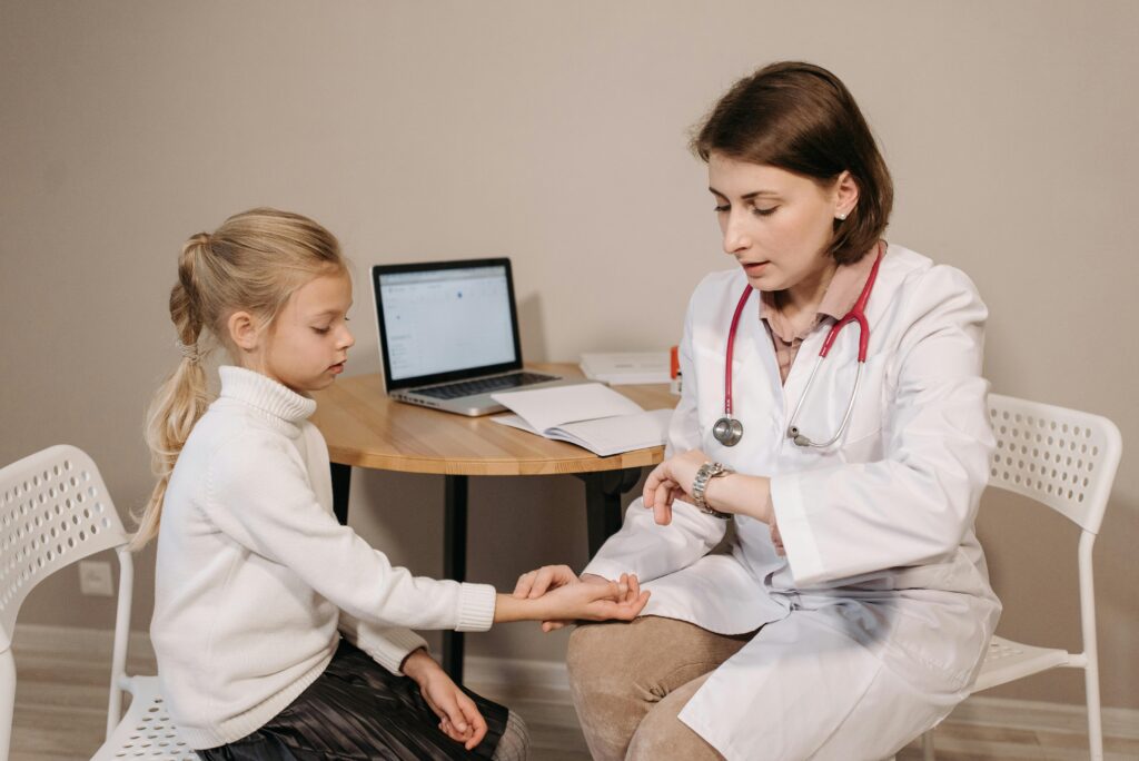 pexels photo 5998450 5998450 A doctor examines a young girl during a pediatric consultation in an indoor clinic setting.
